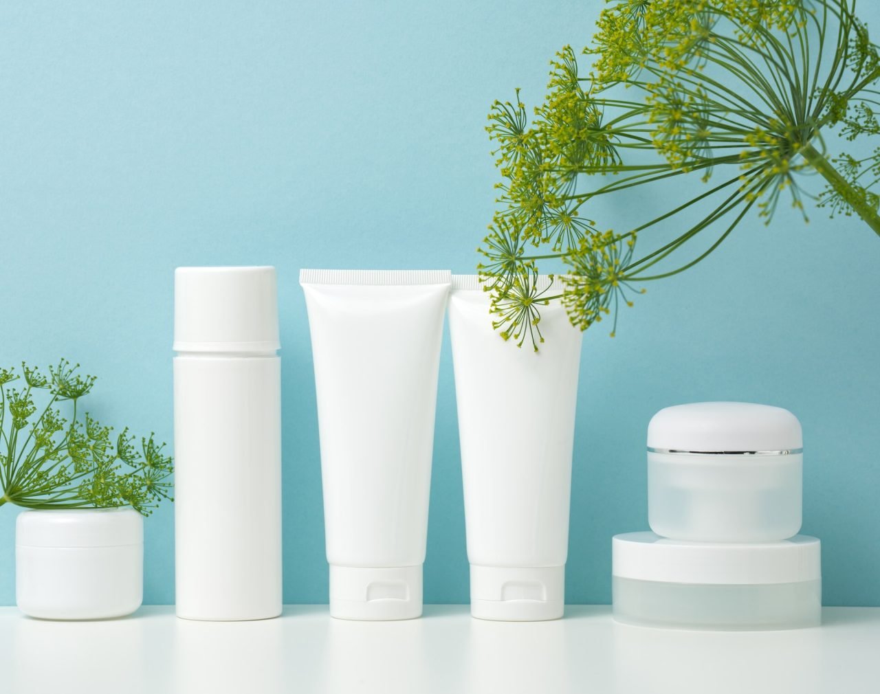 empty white plastic tubes and jars for cosmetics packaging for cream.jpg