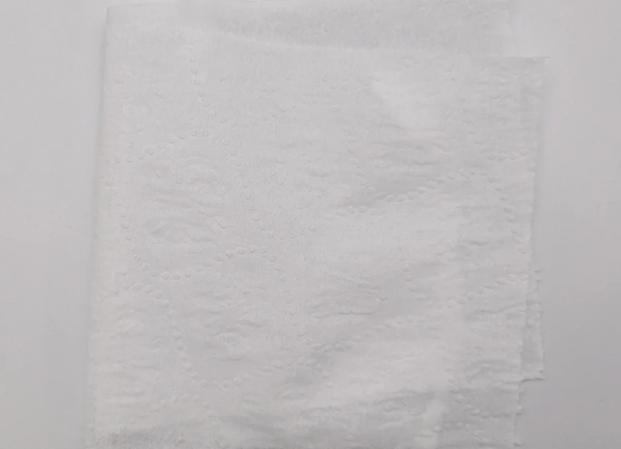 Folded industrial paper wipes beside automotive hand tools