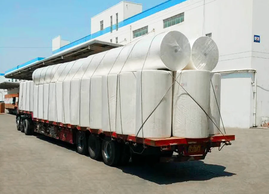 Loaded transport with wrapped paper wiper rolls