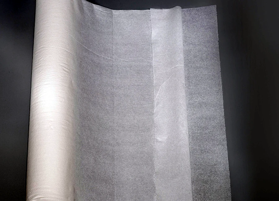Laminated examination roll slitting and perforation process