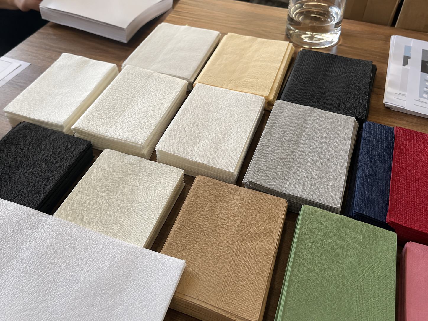 Airlaid napkins bulk color and surface guide with white black kraft tone colored napkins embossing and linen-like texture