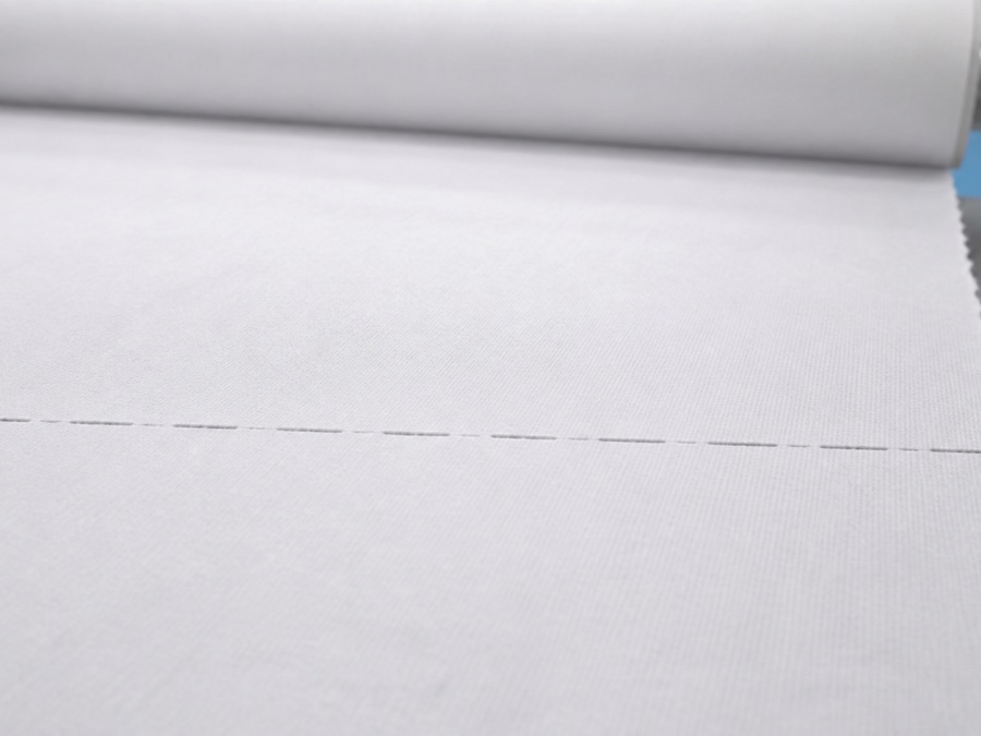 exam couch roll manufacturer — macro close-up of realistic cross-direction perforation ties in white medical exam roll