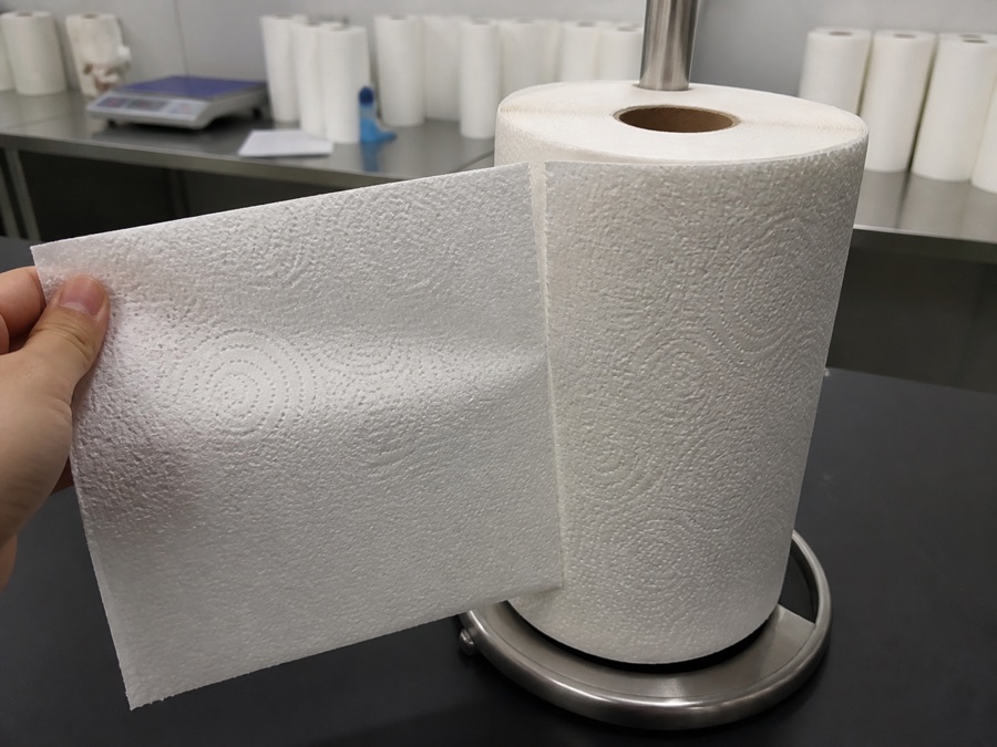 Embossed kitchen towel sheet tested along a perforation line