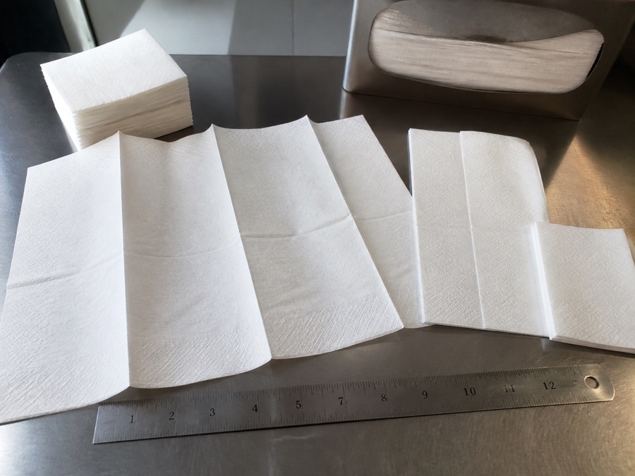 Foodservice paper napkin folds opened for dimension comparison