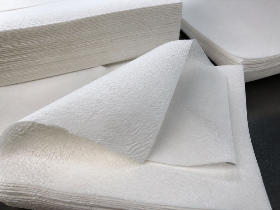 One-ply and two-ply paper napkin edges compared on a QC table