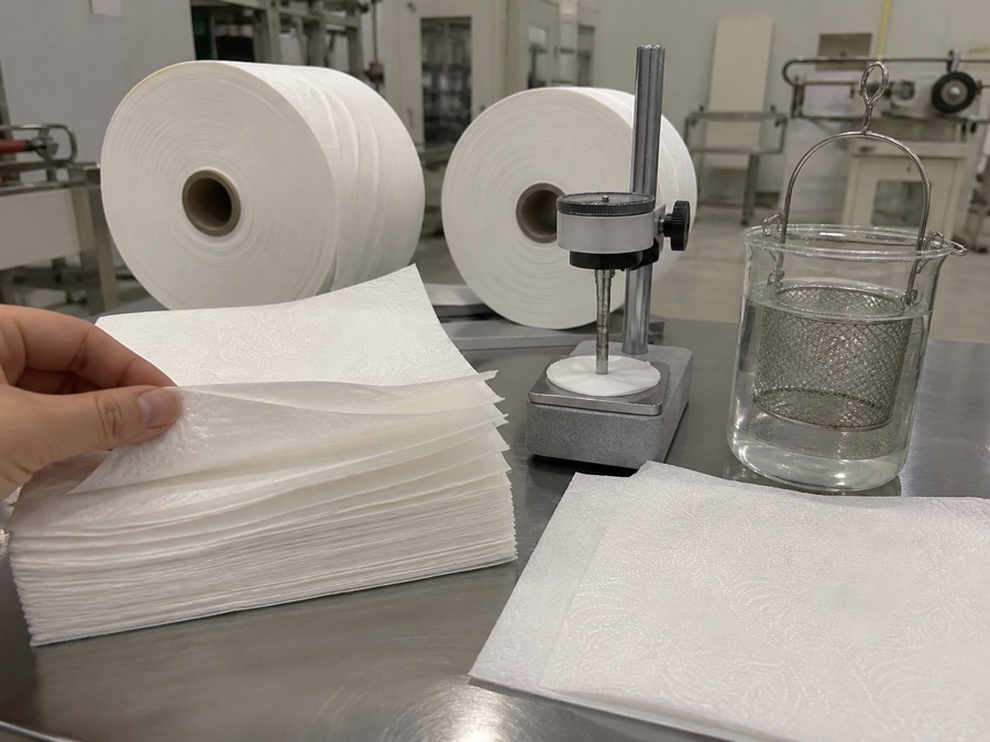 Embossed TAD tissue sheets beside separate bulk and water absorption test setups