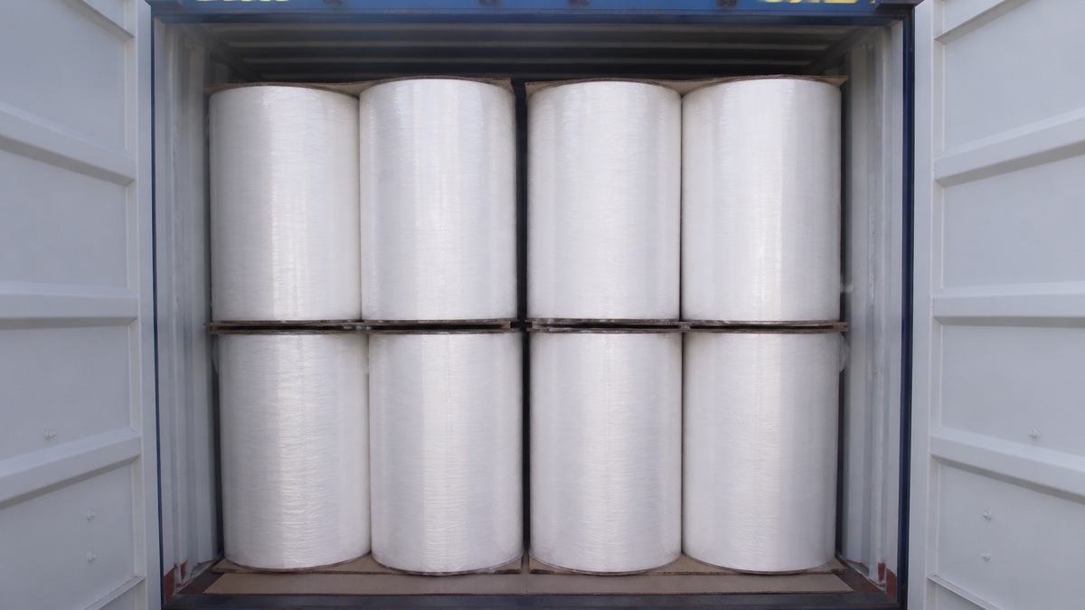tissue mother roll supplier — white tissue mother rolls safely loaded inside a clean dry shipping container with protective wrapping and