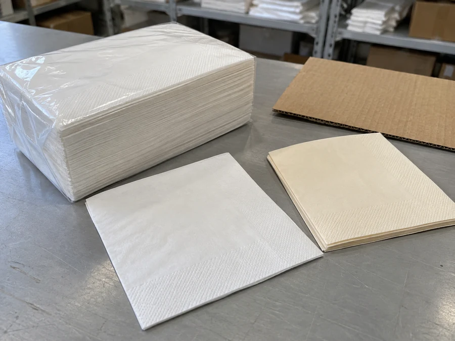 Wrapped napkins, loose sheets and a piece of corrugated board