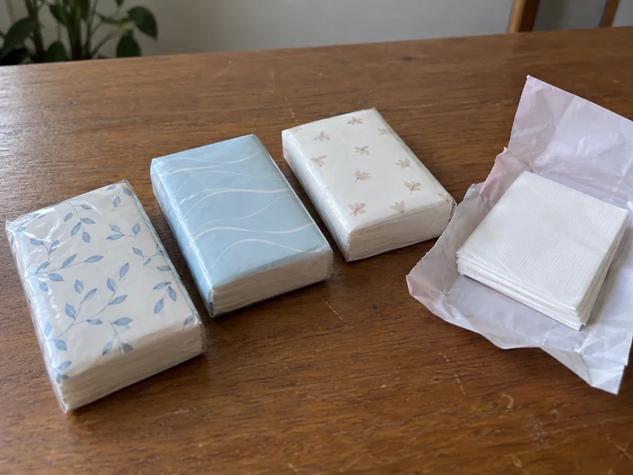 Wrapped pocket tissue mini packs on a wooden table