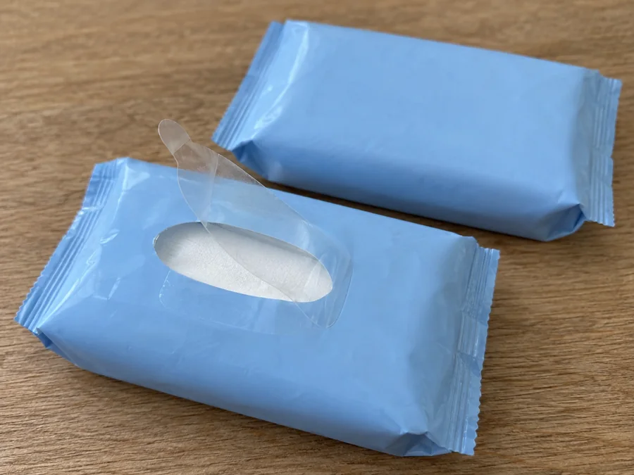 Blue pocket tissue pack with an oval opening beside another pack