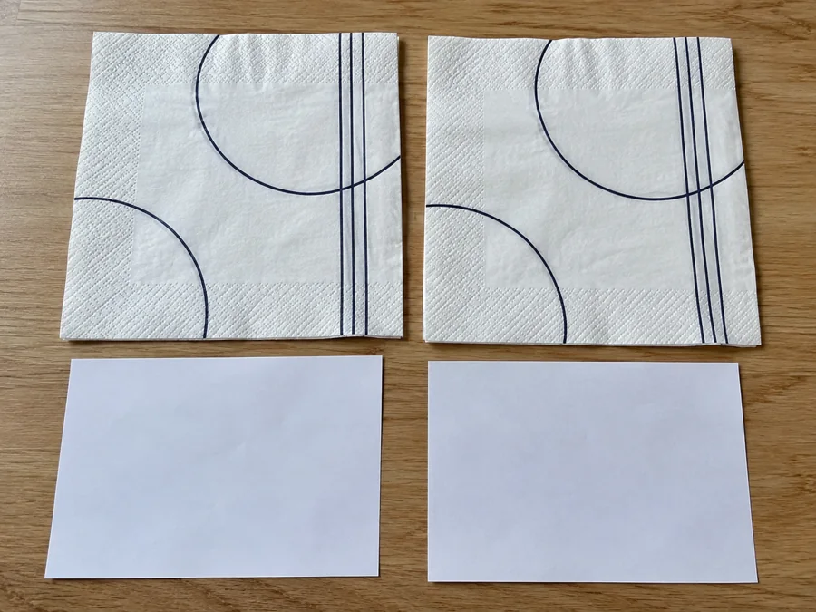 Matched printed napkin specimens beside separate white paper sheets