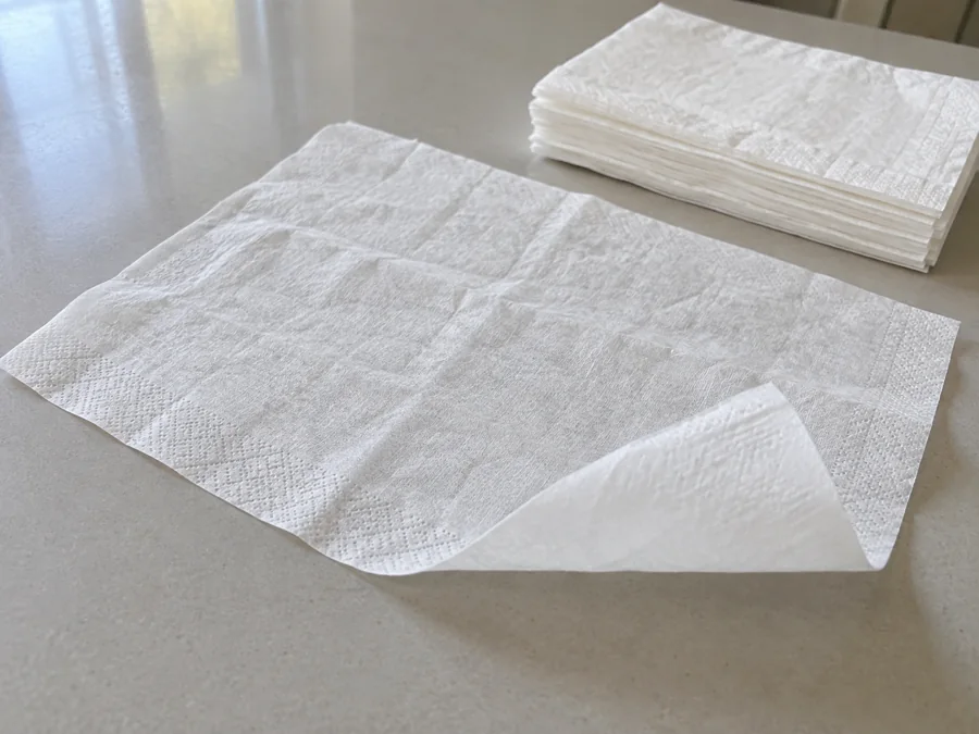 Facial tissue sheet showing its surface and thin layered edge